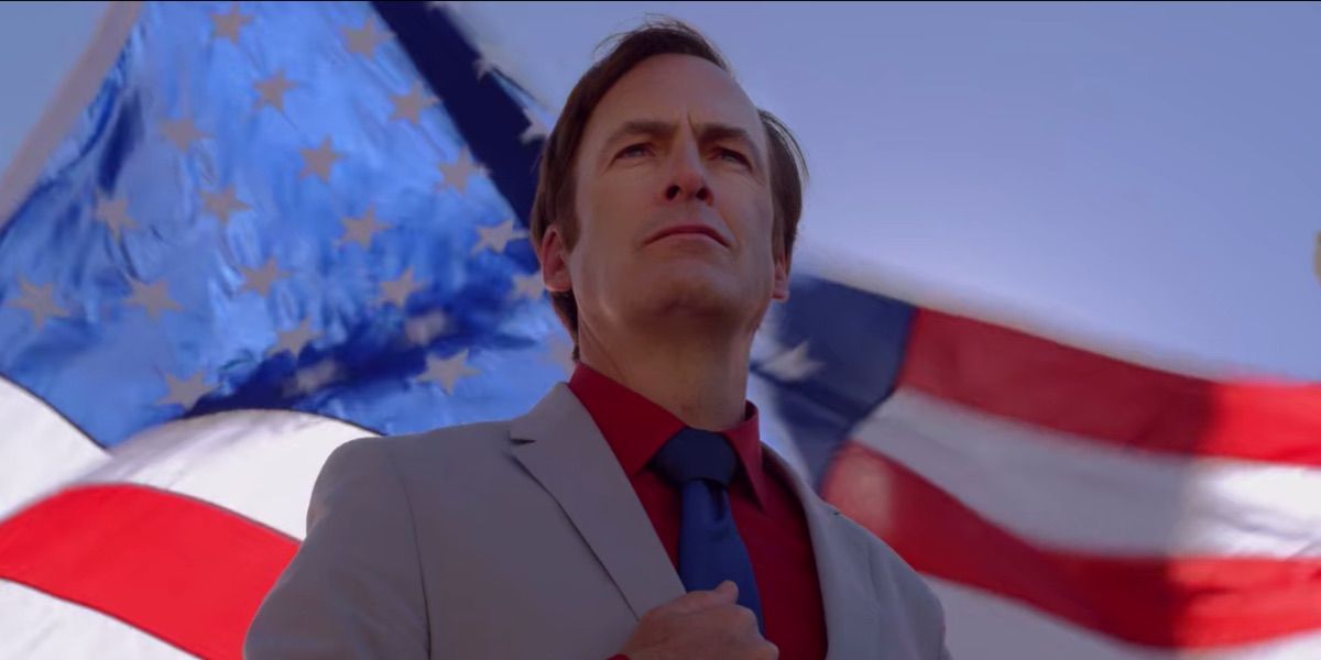 Saul Goodman poses in front of an American Flag