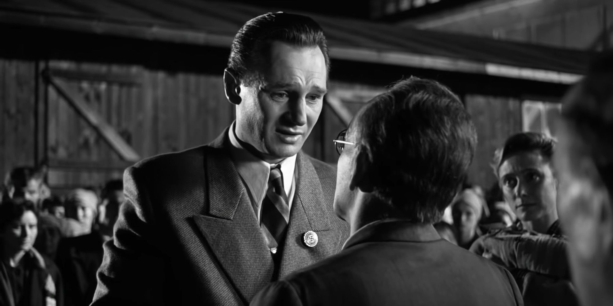 Liam Neeson as Oskar Schindler crying while facing a man in Schindler's List