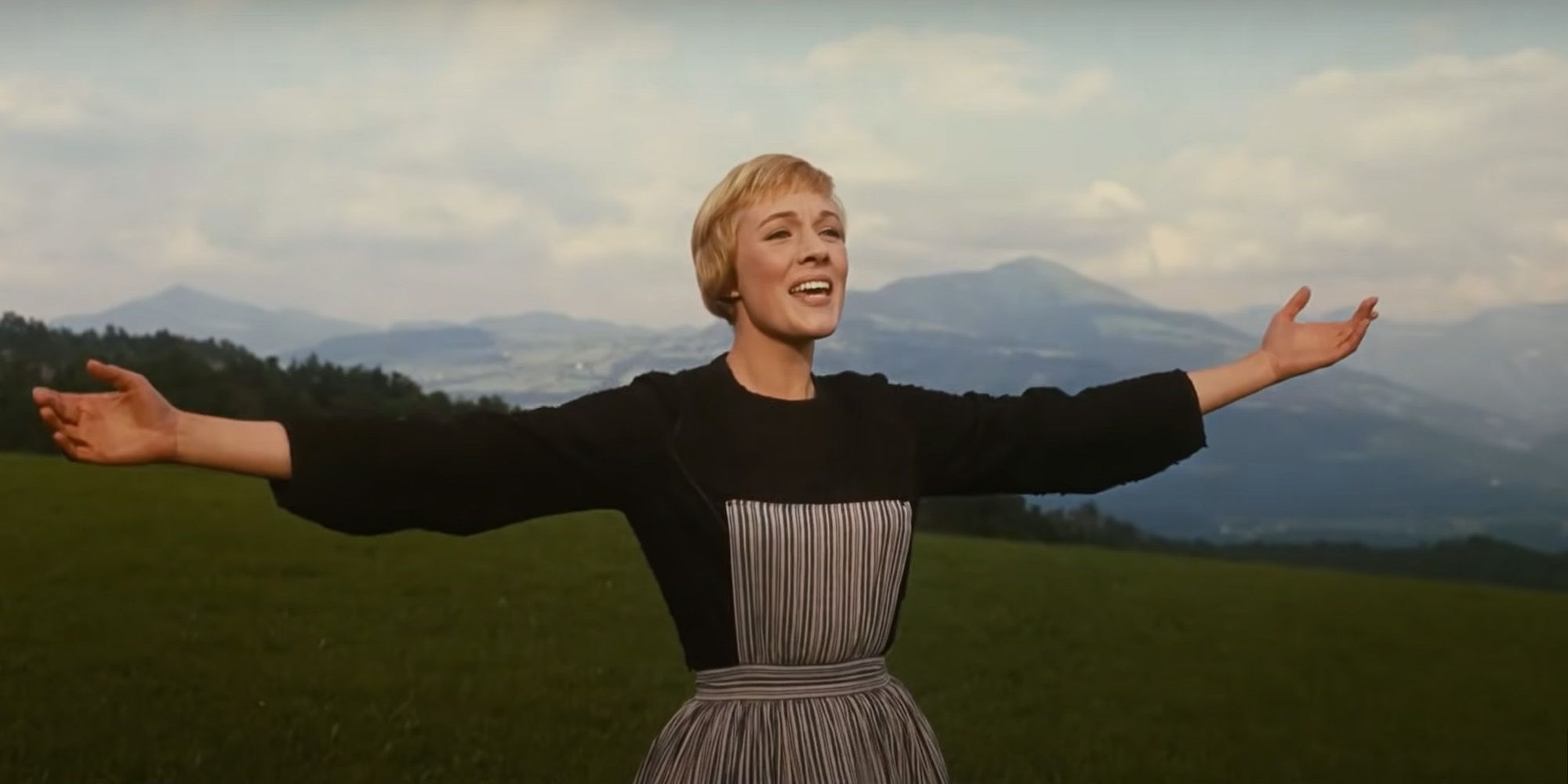 Maria spreading her arms while singing in The Sound of Music