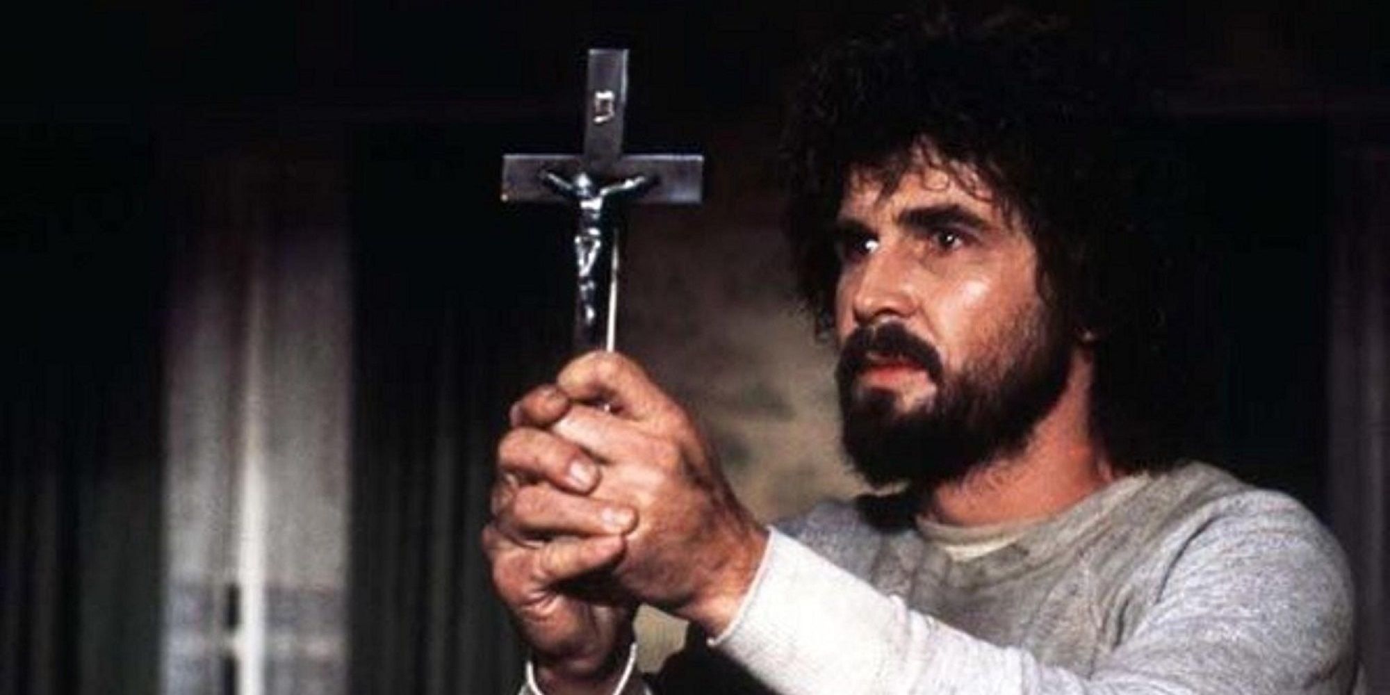 The Amityville Horror - George holding up a cross with both hands