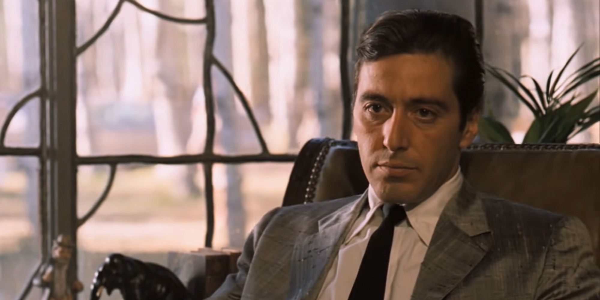 Al Pacino as Michael Corleone sitting in a chair in The Godfather Part II