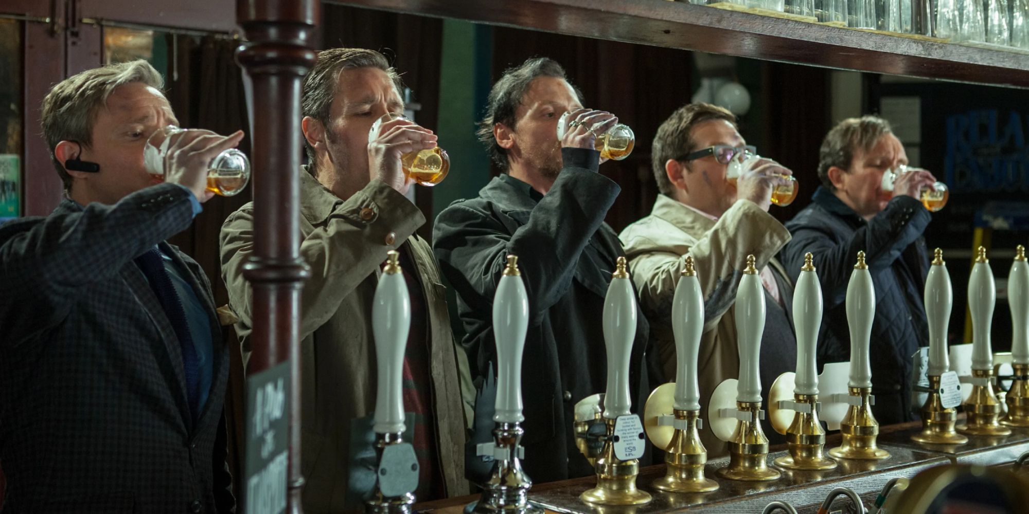 Five men drinking in sync at a bar in The World's End.