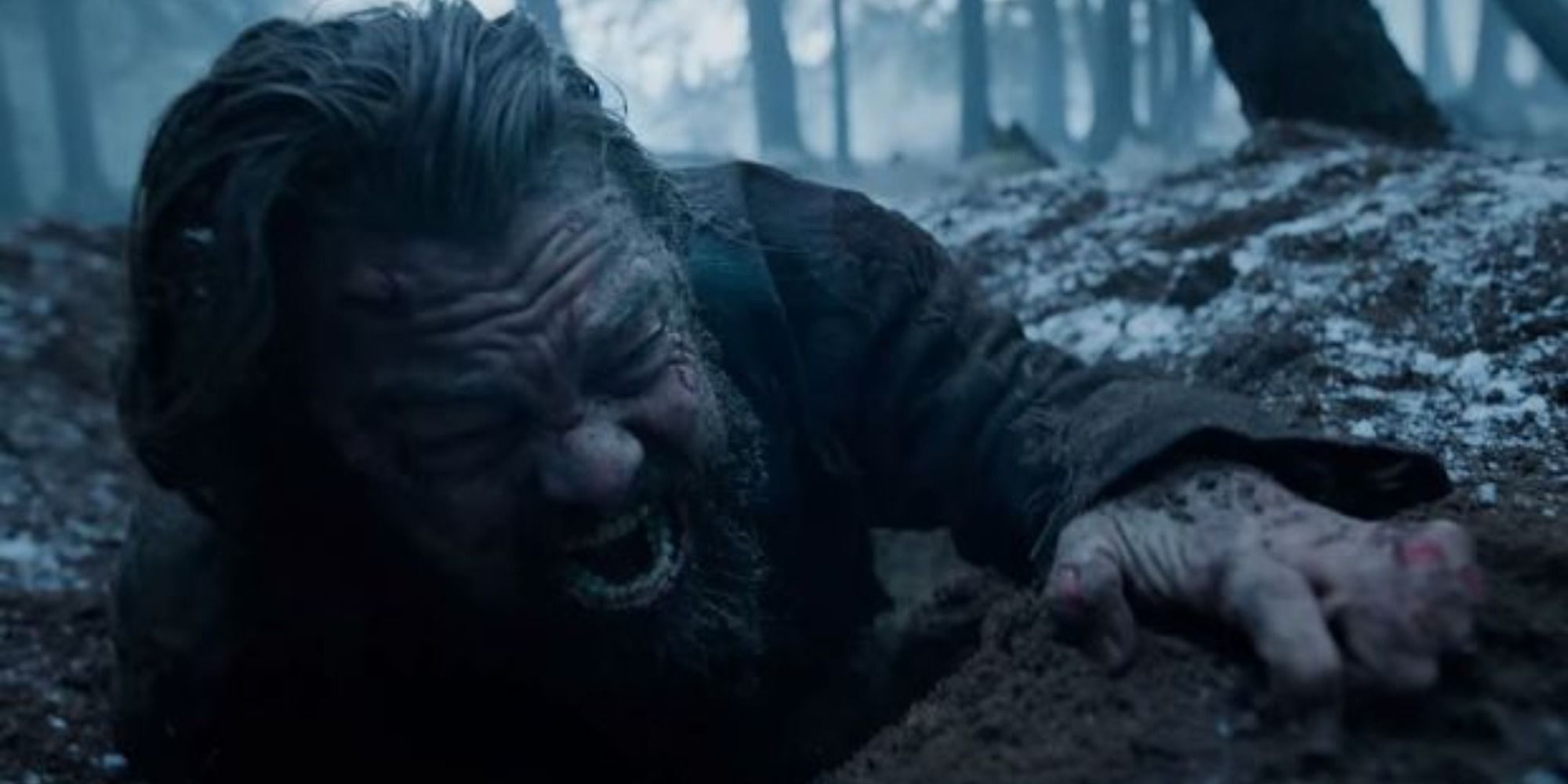 Leonardo DiCaprio as Hugh Glass in the mud during bear attack in The Revenant 