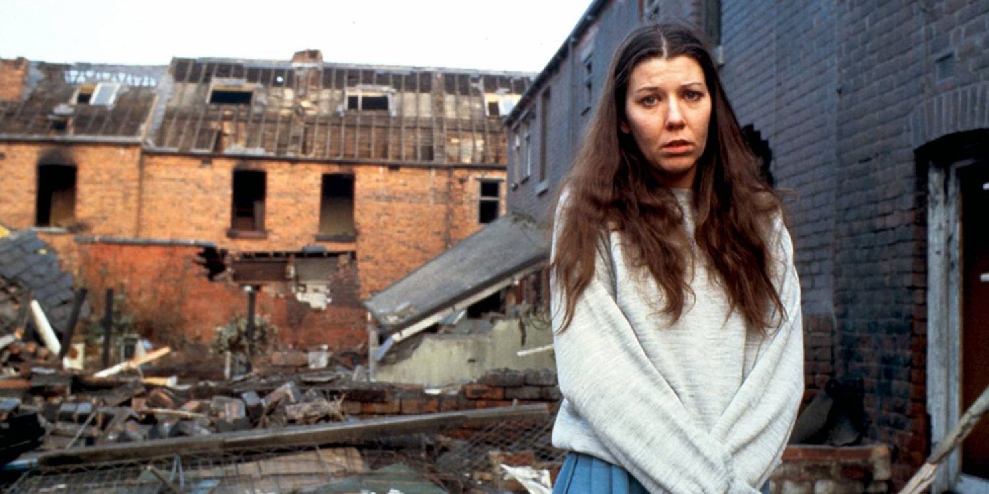 Ruth standing in front of rubble in Threads