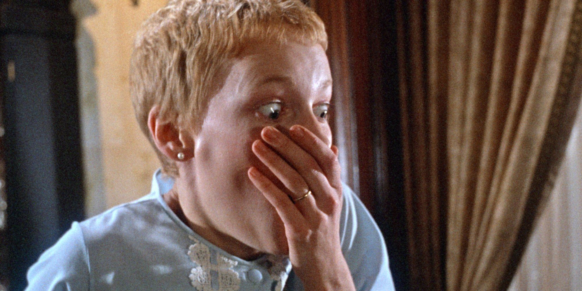 Mia Farrow as Rosemary, covers her mouth in terror, in Rosemary's Baby