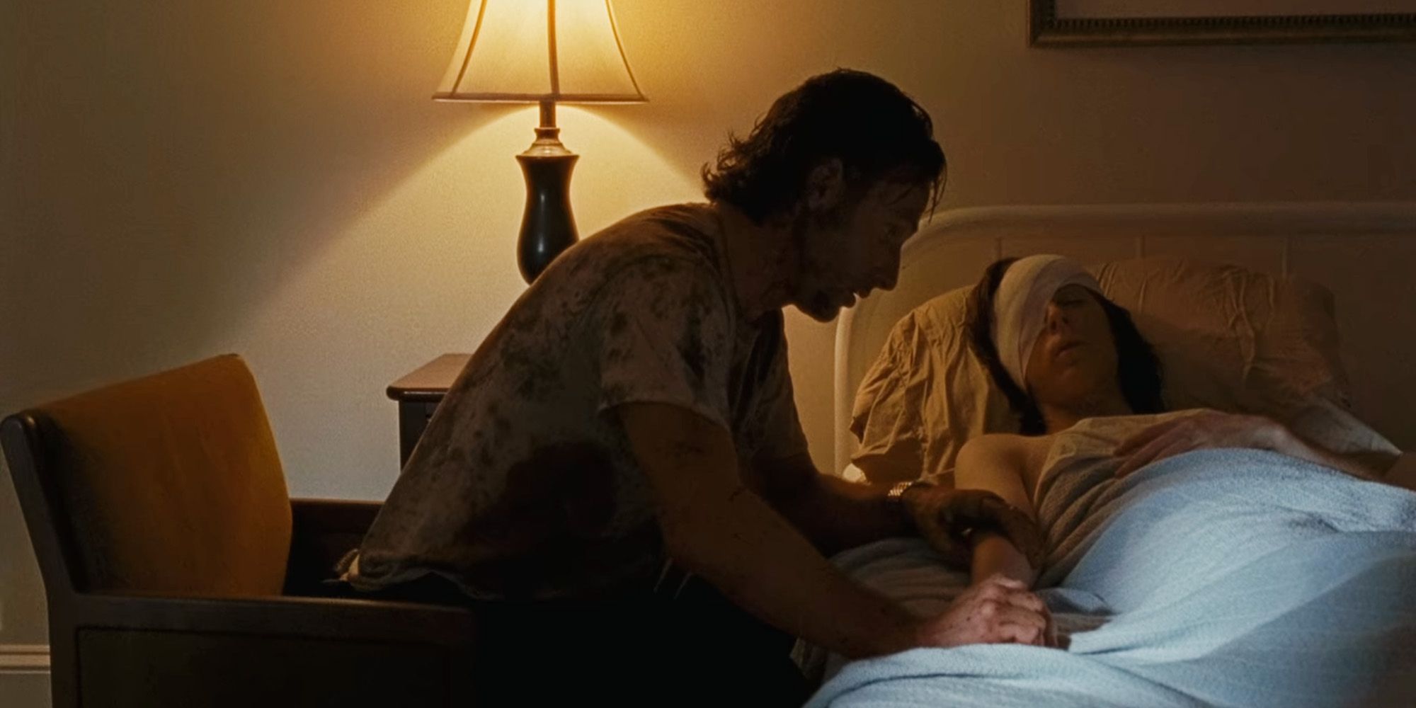 Rick sitting beside an unconscious Carl in The Walking Dead