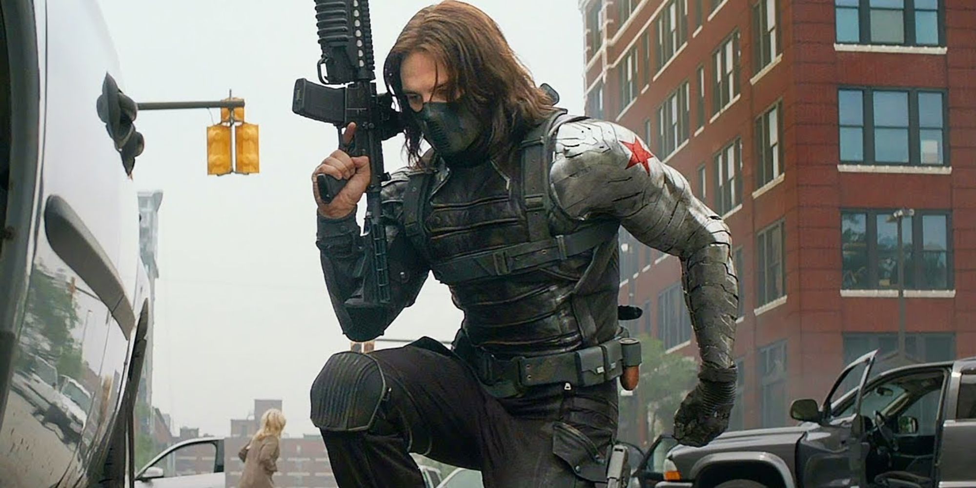 Sebastian Stan as the Winter Soldier kneeling while holding a gun in Captain America: The Winter Soldier.