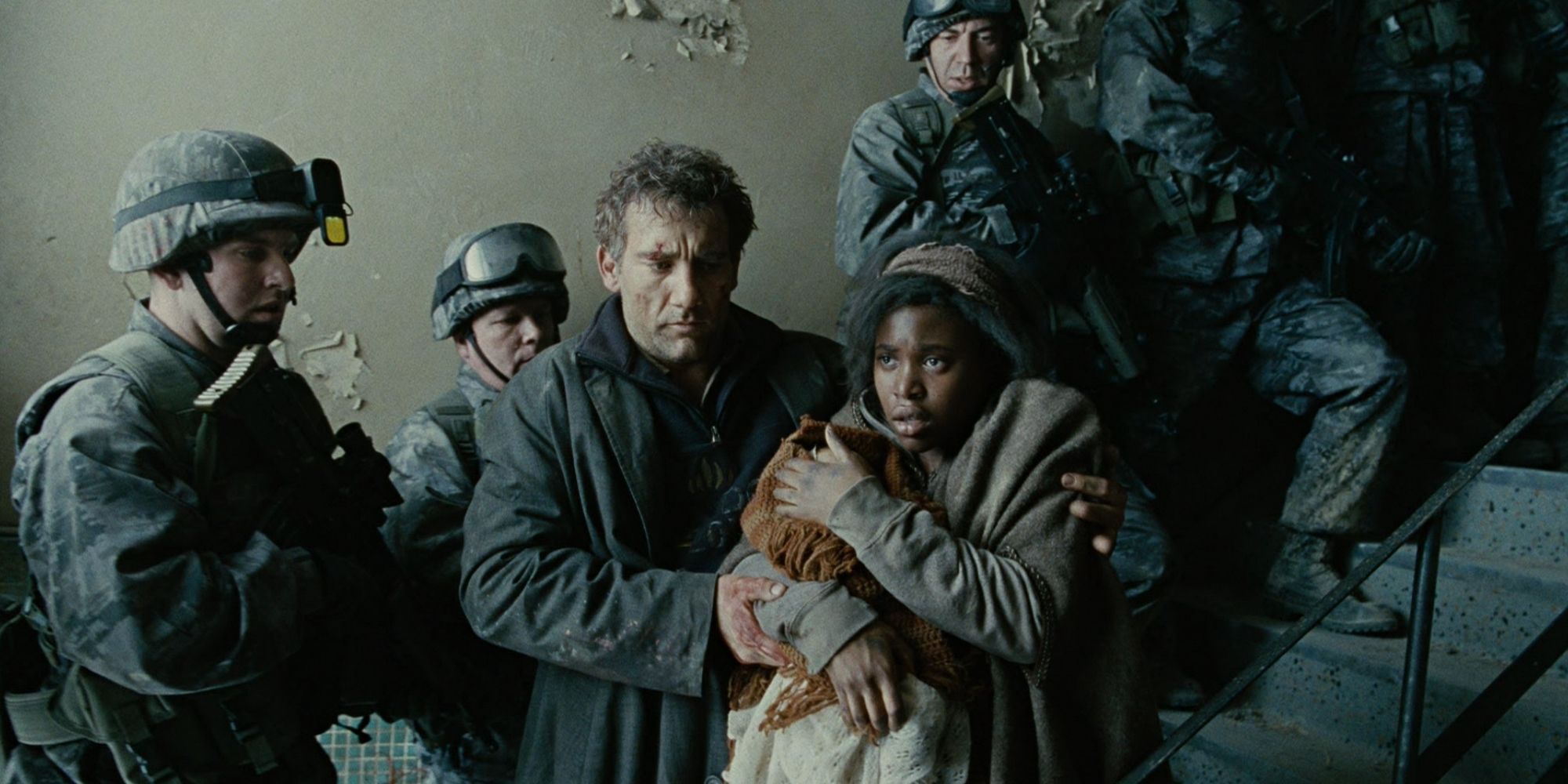 Theo escorts Kee and her newborn baby down a staircase lined up with soldiers in Children of Men