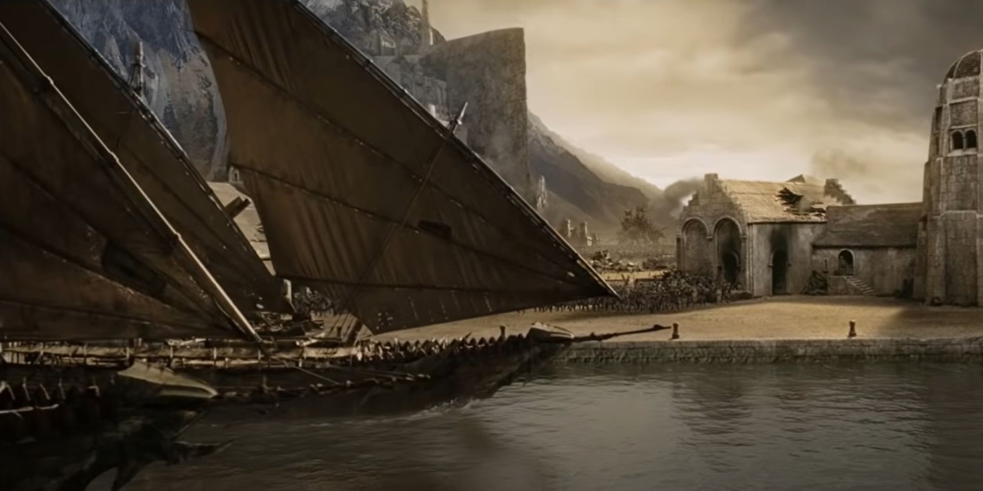 Ships of Umbar arrive at the harbour as the battle of Pelennor fields rages on in the background