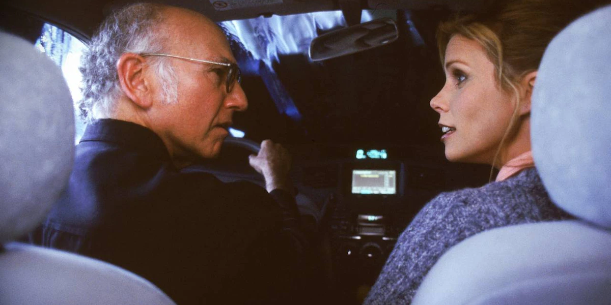 Larry driving with his wife, Cheryl (Cheryl Hines)
