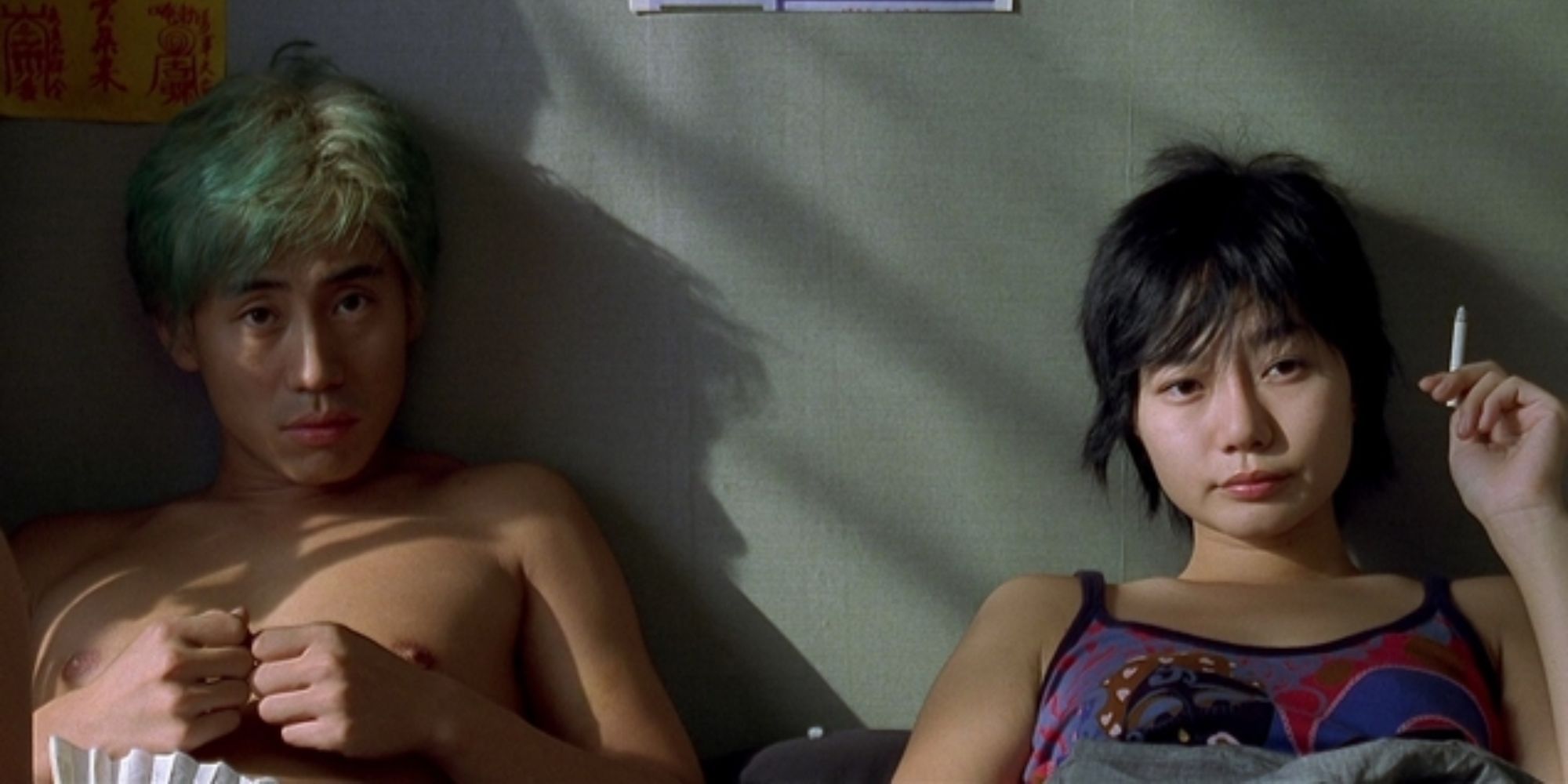 a man and a woman are sitting on the bed