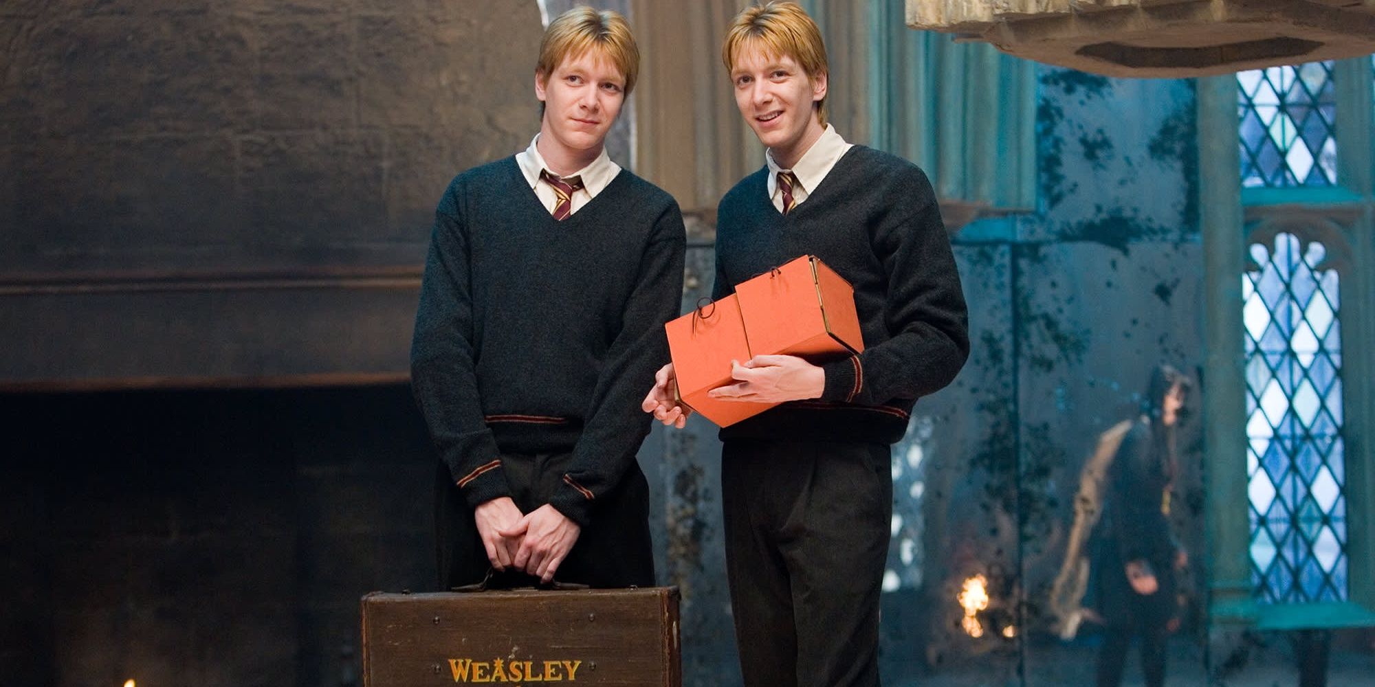 fred and george weasley from harry potter holding bags at hogwarts