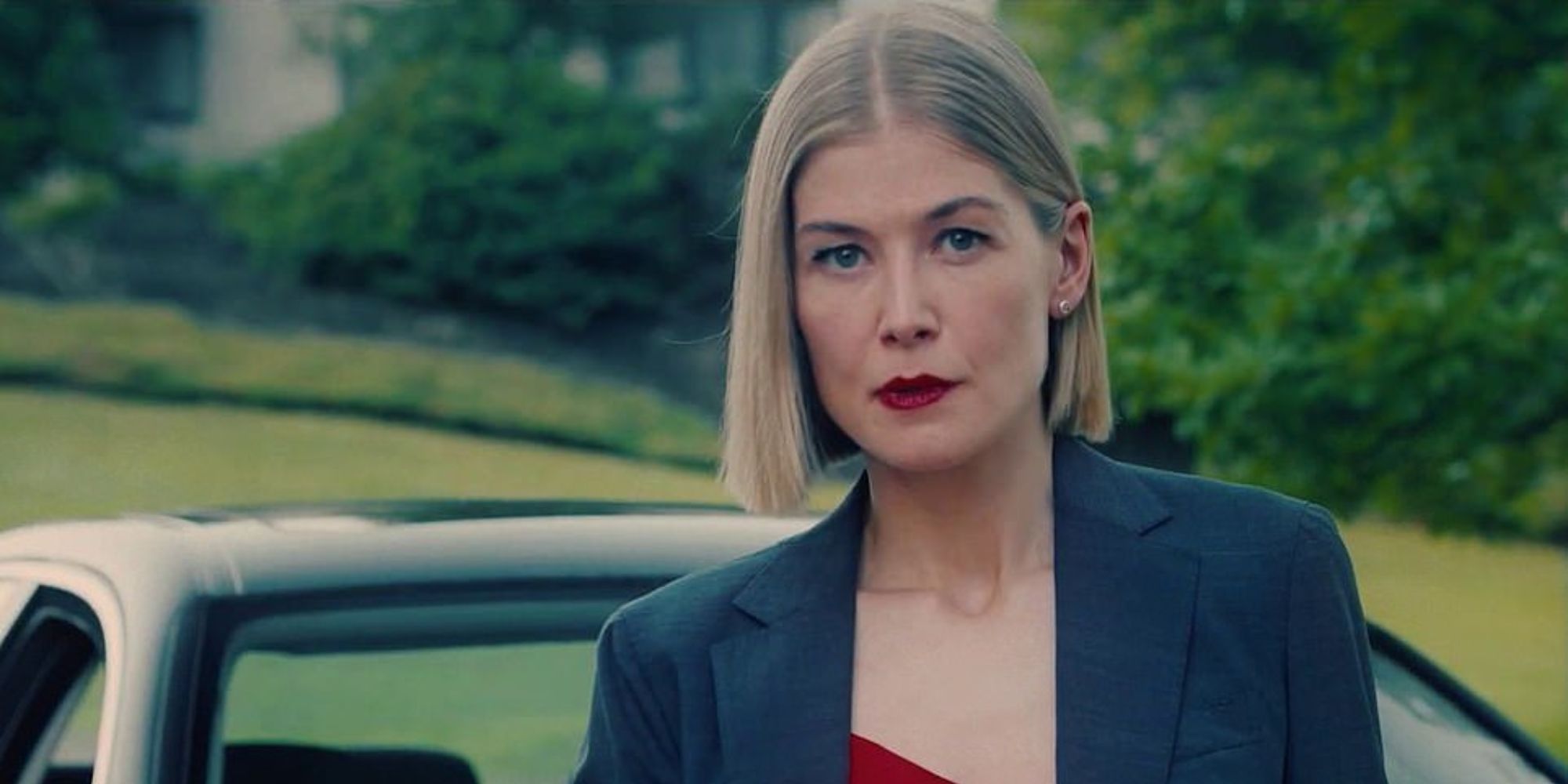 Blonde lady in suit and red lips looking sharp