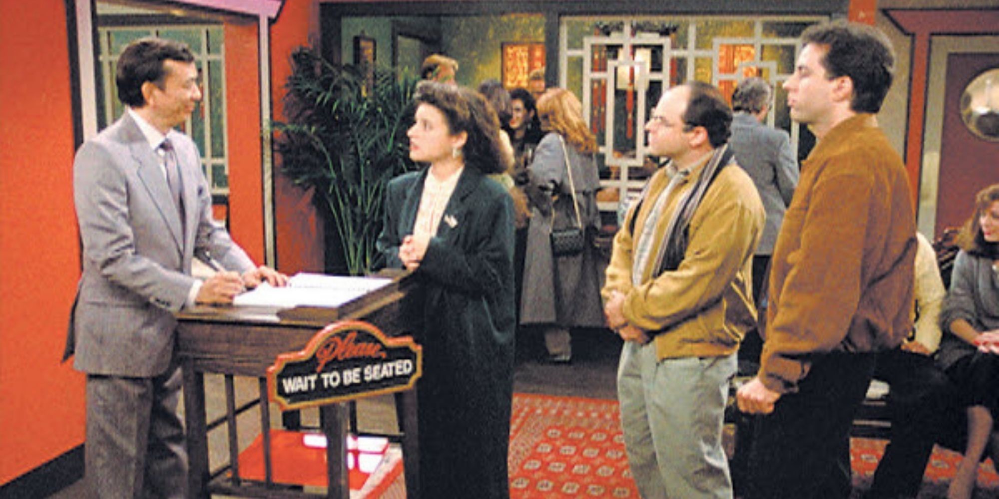 james hong in seinfeld at the host stand talks to elaine jerry and george
