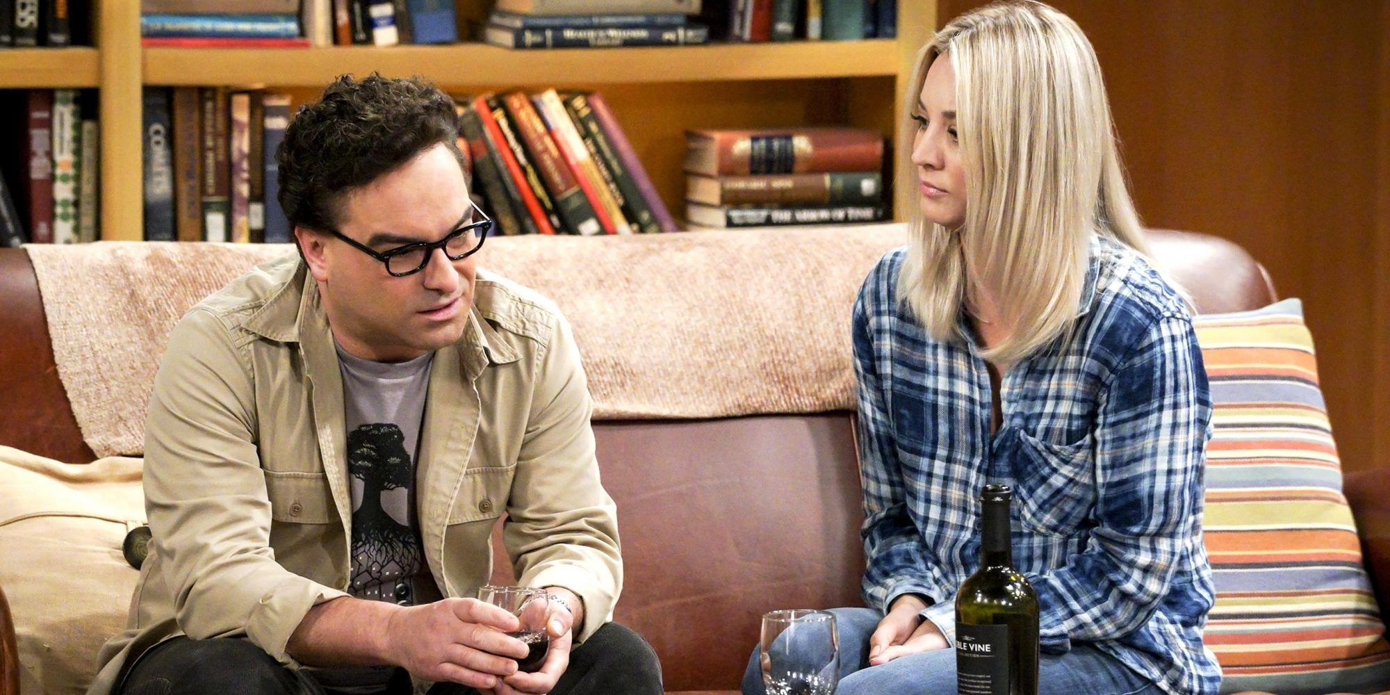 leonard and penny sat on their couch in their apartment from the big bang theory