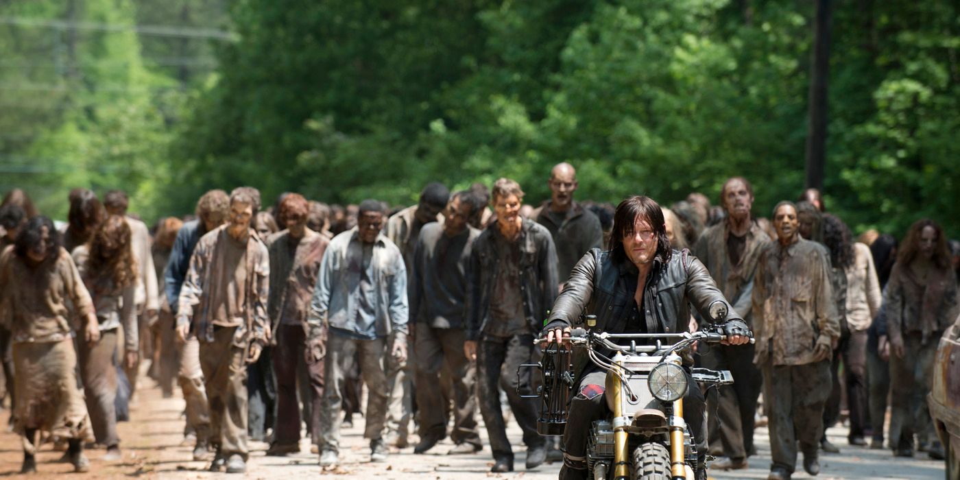 A herd of zombies follow Daryl Dixon as he rides his motorbike in 'The Walking Dead'.