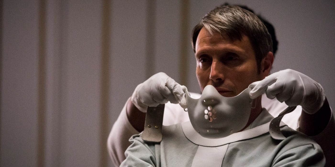 Hannibal Lecter held captive and about to be muzzled in Hannibal.