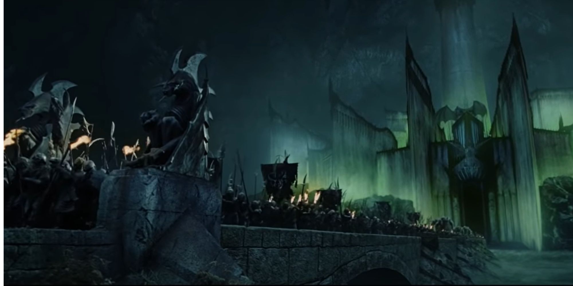 An army of orcs mobilizes from Minas Morgul, which sits in the background, a Nazgul perched atop. 