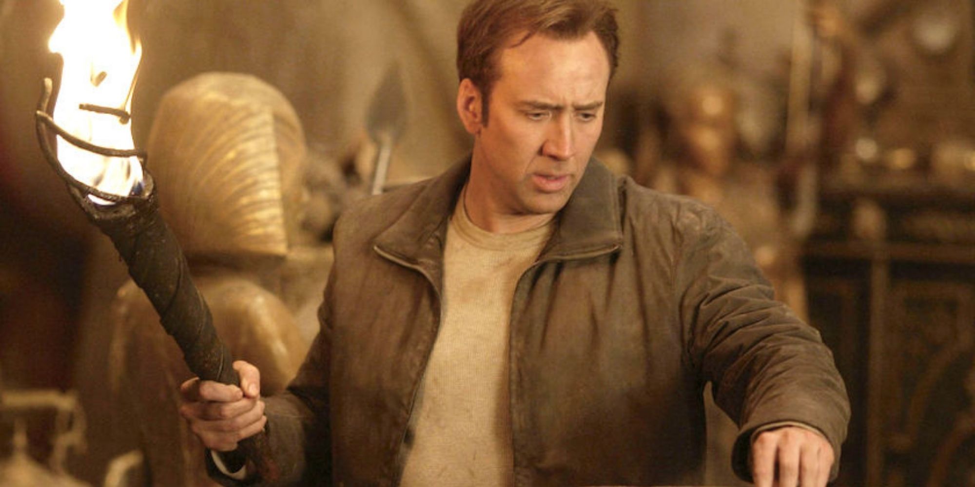 Nicolas Cage as Ben Gates holding a torch in National Treasure