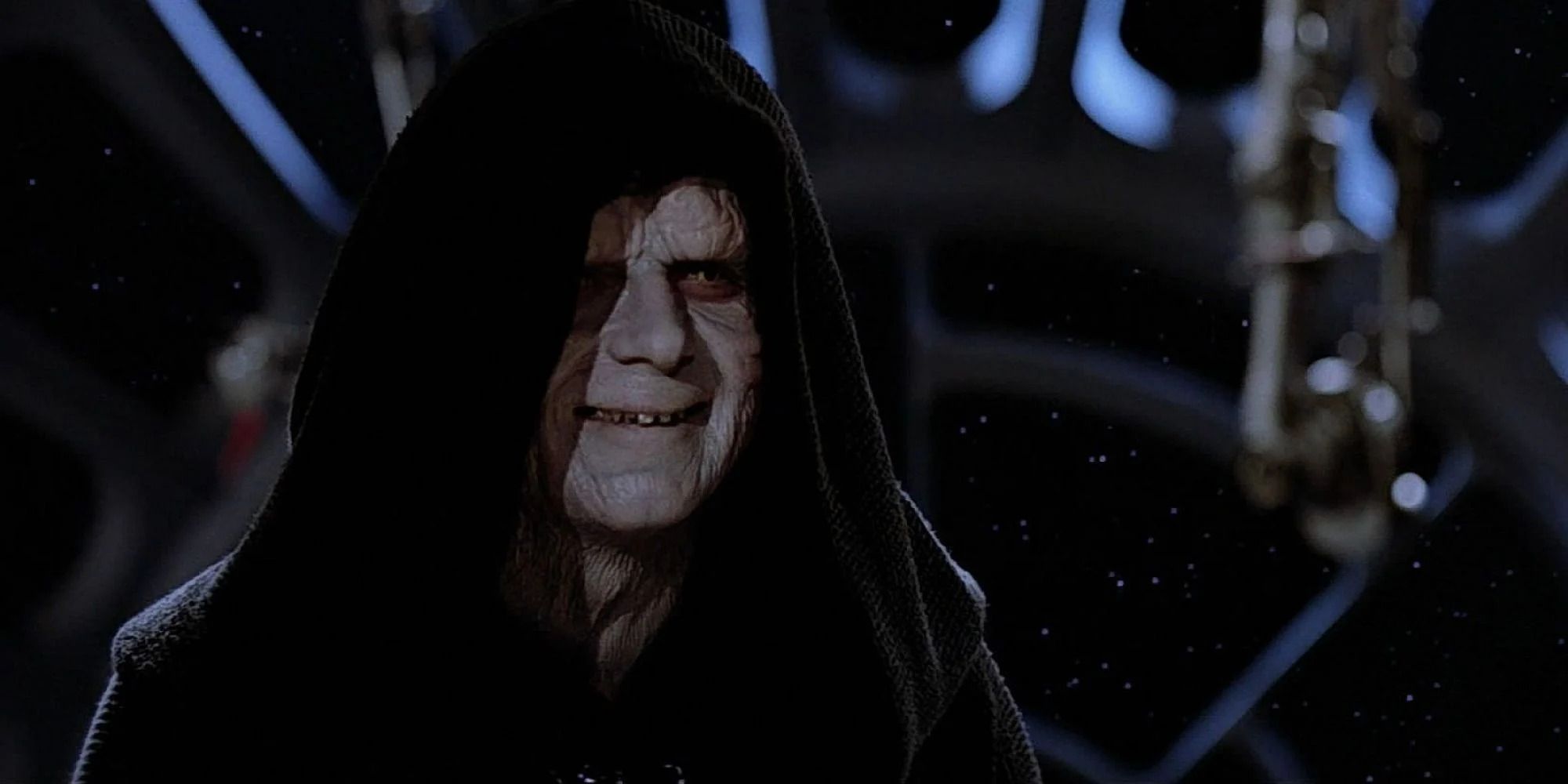 Emperor Palpatine from 'Star Wars', smiling smugly in a dark room 