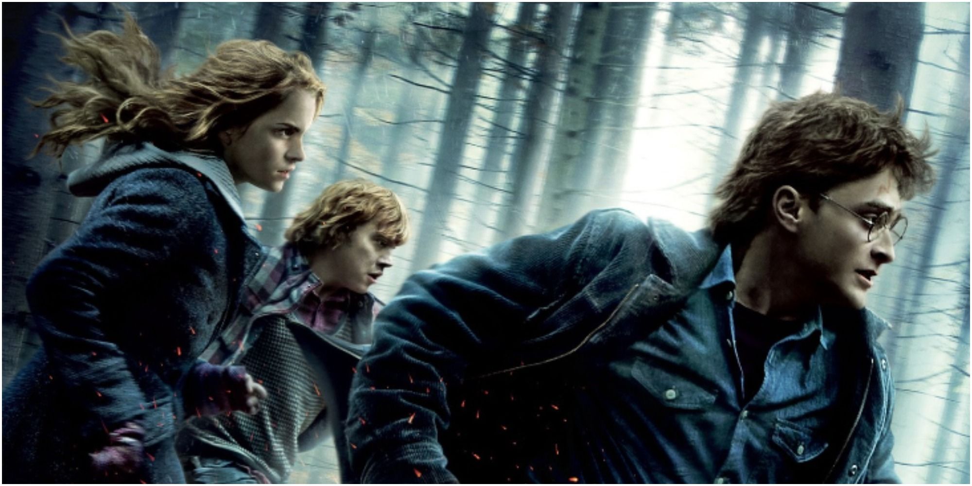 Danielle Radcliffe, Emma Watson, and Rupert Grint running through the woods in a promo poster for Harry Potter and the Deathly Hallows Part I