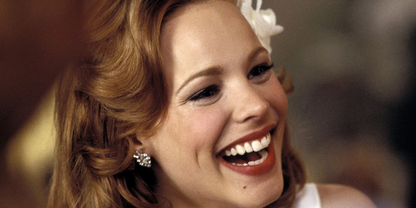 Rachel McAdams as Allie smiling and wearing a white dress in a 'The Notebook' party scene.