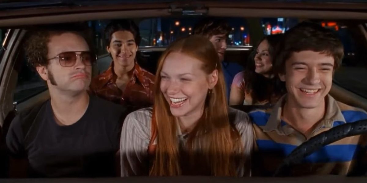 Five teenage friends laughing in a car in That &rsquo;70s Show.