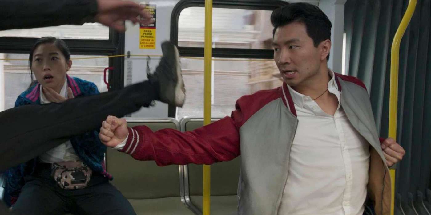 Simu Liu punches someone on a bus as Shang Chi