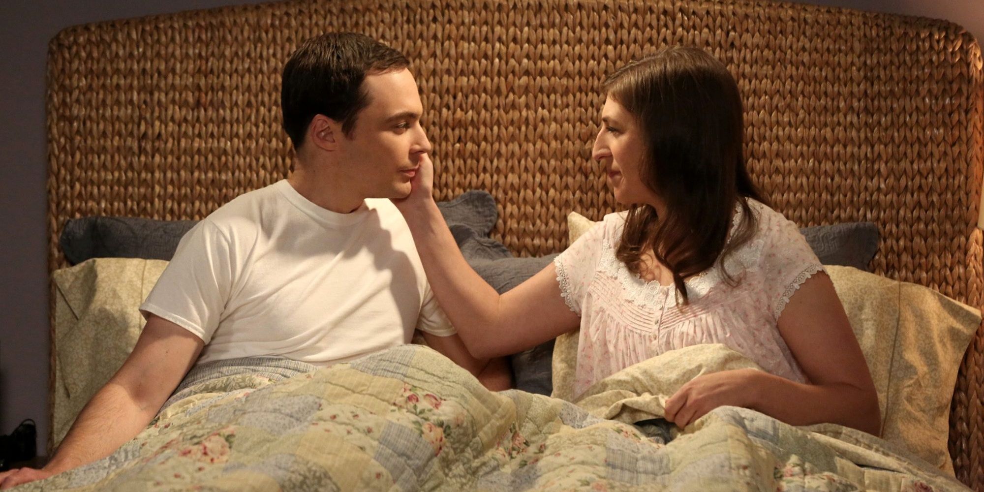 sheldon and amy sit together in bed on the big bang theory