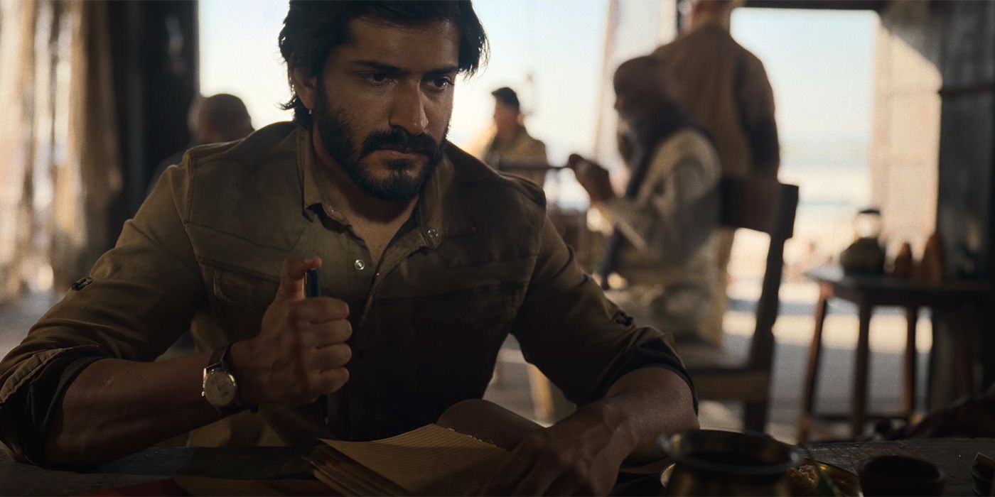 A young soldier sitting on a table looking pensive in Thar