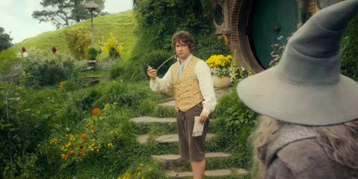 Martin Freeman as Bilbo Baggins in 'The Hobbit' with a pipe in front of the green Shire