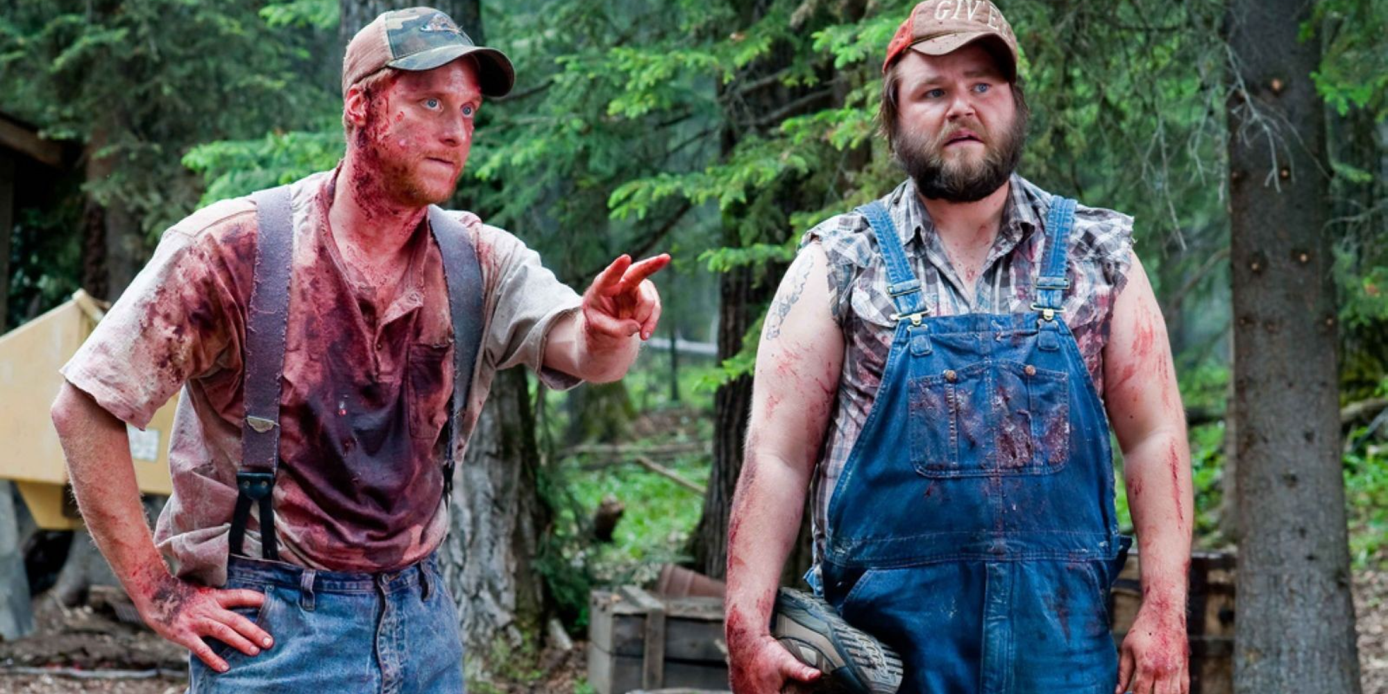 Alan Tudyk and Tyler Labine covered in blood in the woods in Tucker & Dale vs Evil
