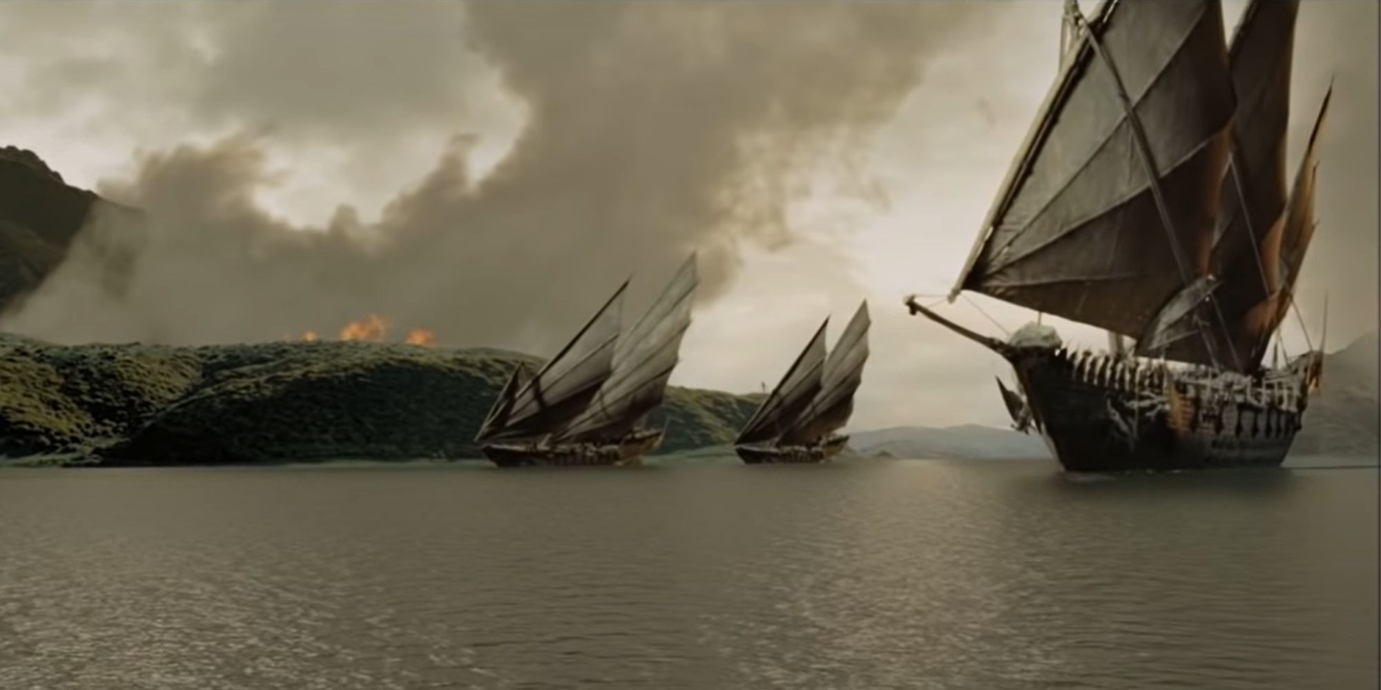 Ships of Umbar sail down a river; an inferno burns in the background.