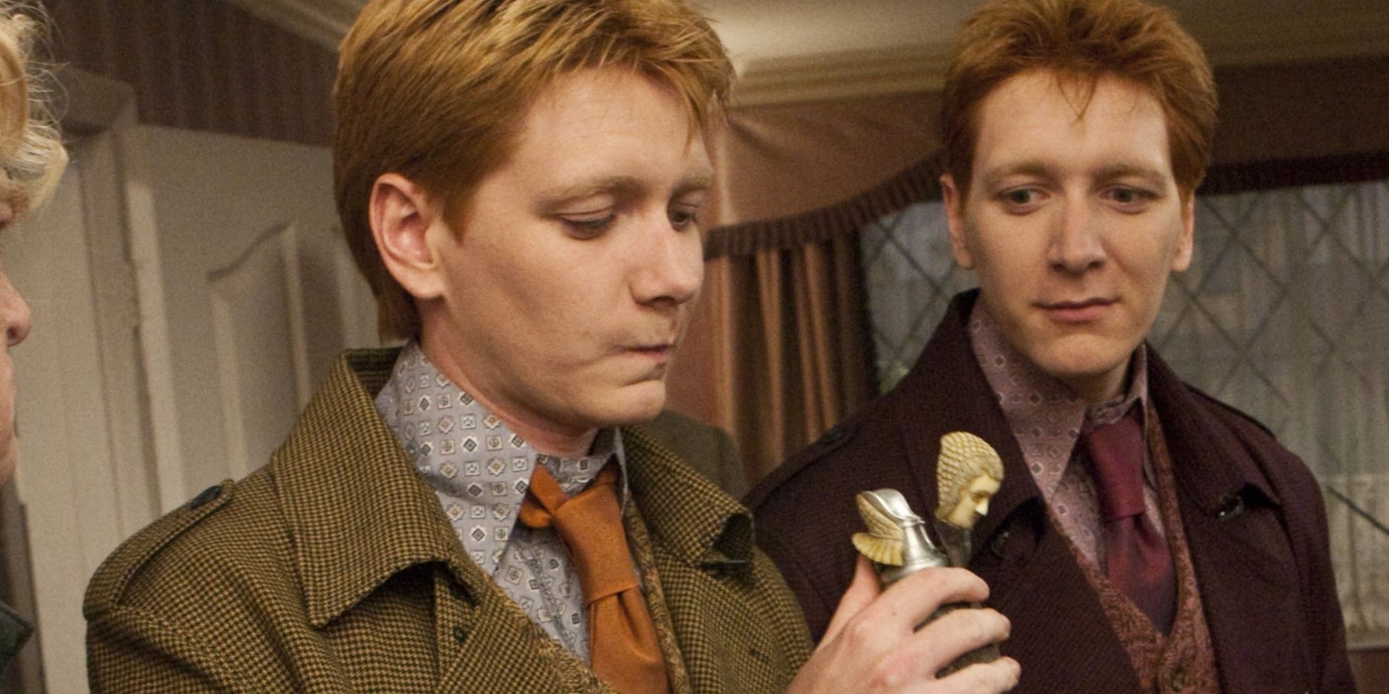 The Weasley Twins looking at a flask in Harry Potter and the Deathly Hallows Part 1.