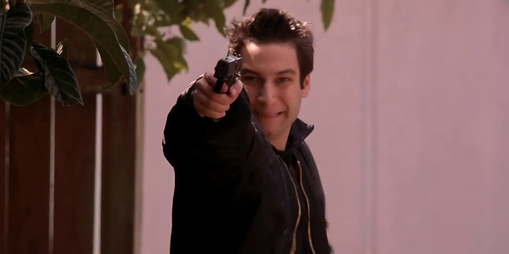Warren in Buffy the Vampire Slayer holding up gun towards camera