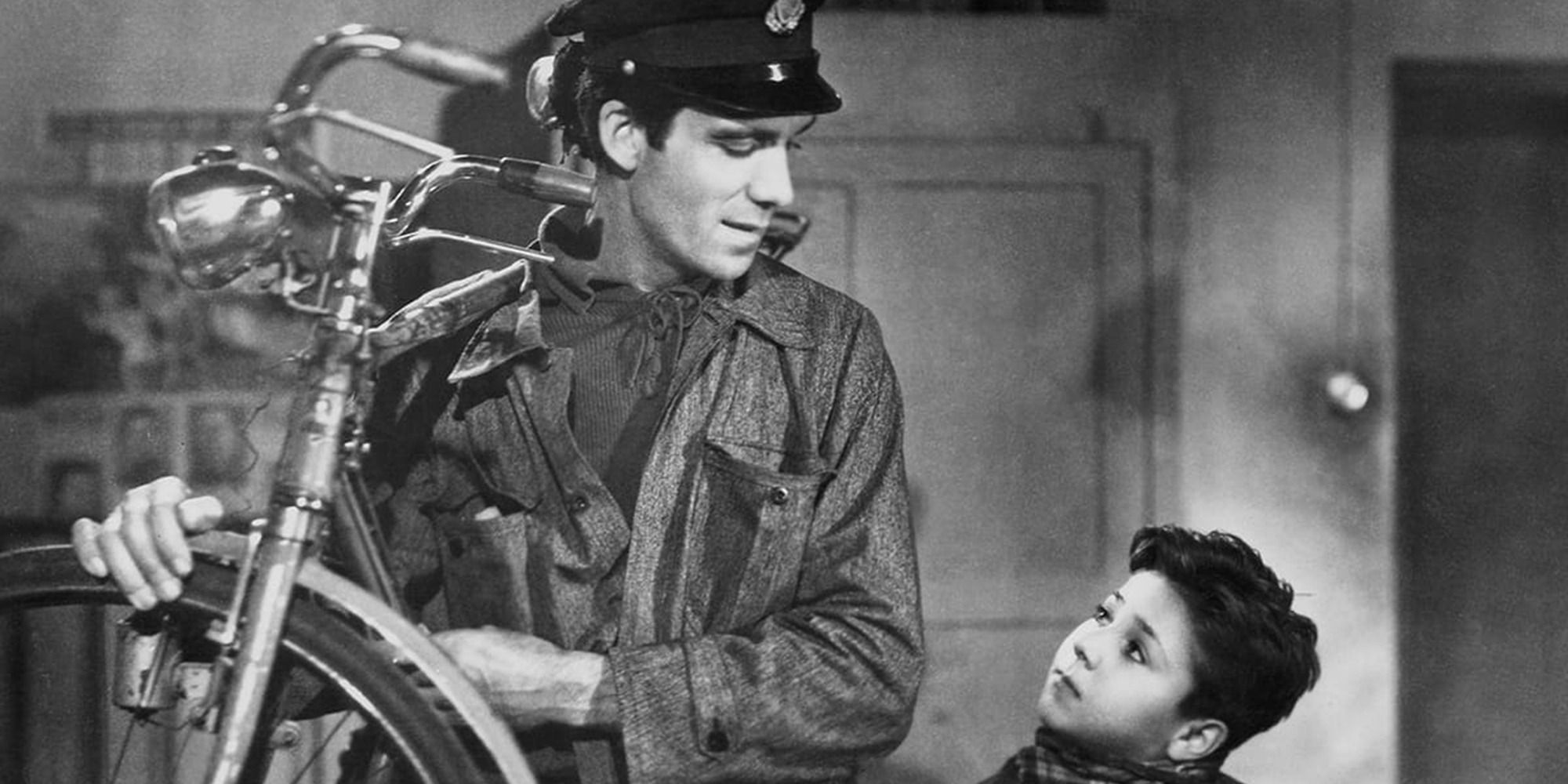 Antonio and Bruno from "Bicycle Thieves", Antonio holding a bike and Bruno looking up at him