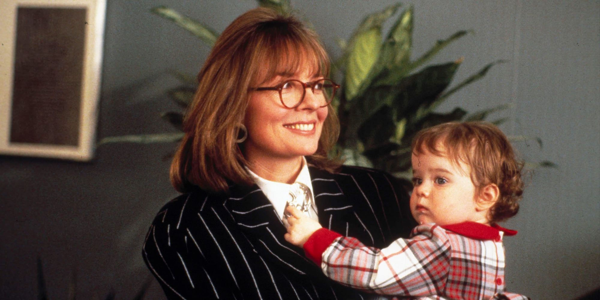 Diane Keaton holding a baby in Baby Boom