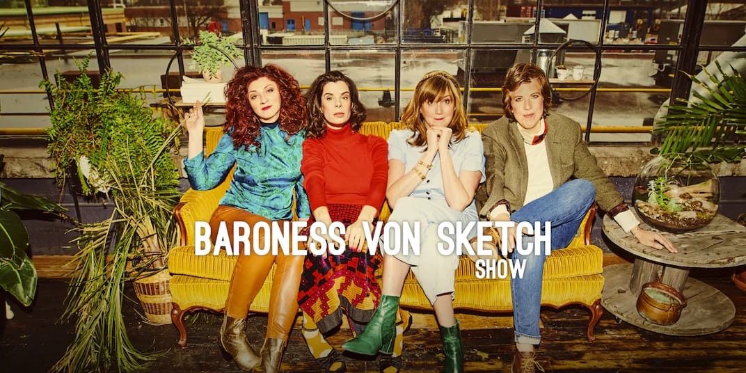 A title card from the Baroness von Sketch Show featuring four ladies sitting on a couch