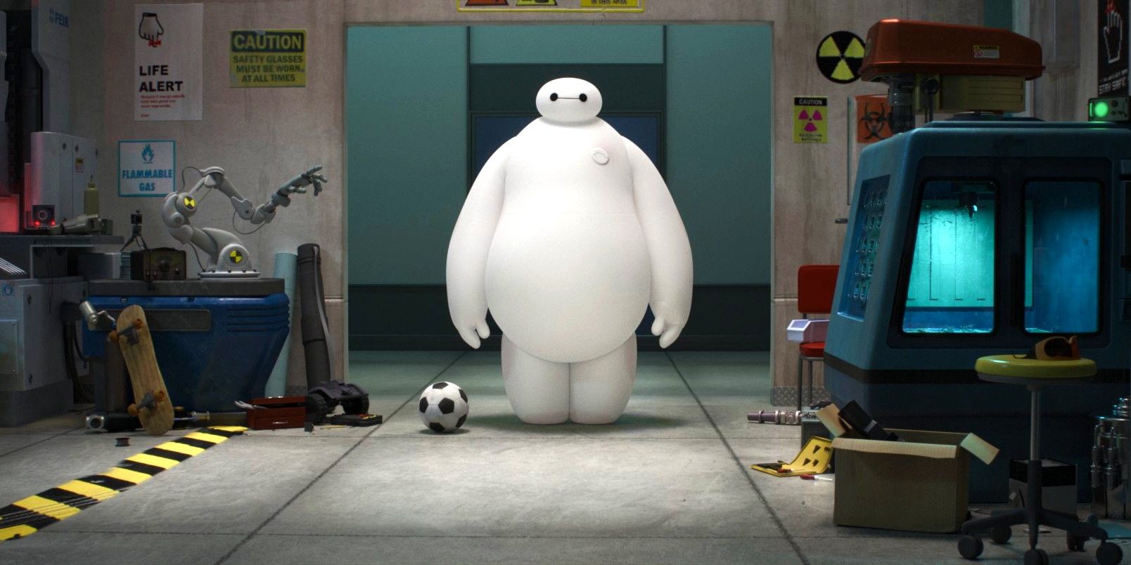 Inflatable robot Baymax stands in a testing facility next to a soccer ball. 