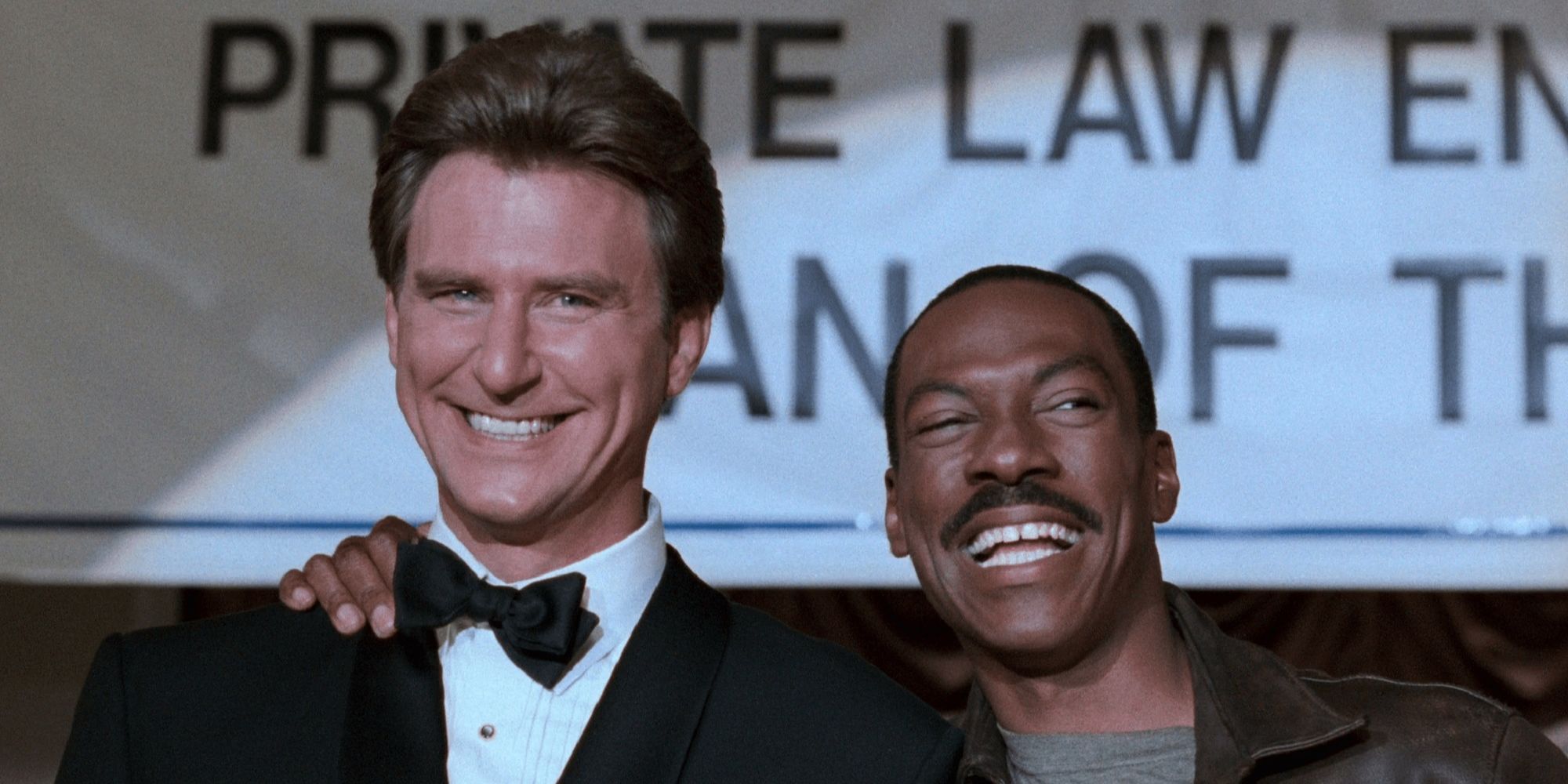 Axel Foley with his arm around Ellis DeWald's shoulders in Beverly Hills Cop III