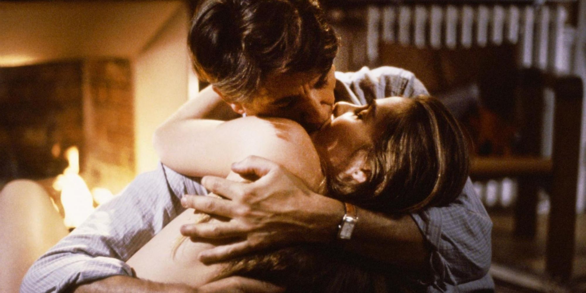 Peter Coyote and Emmanuelle Seigner as Oscar and Mimi kissing in Bitter Moon