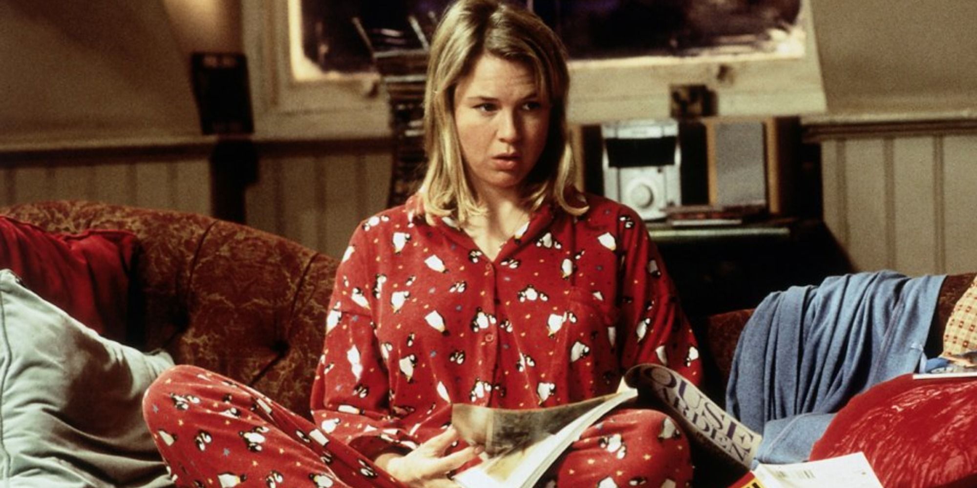 Rene Zellweger as Bridget Jones in her pyjamas looking confused on the couch in Bridget Jones's Diary.