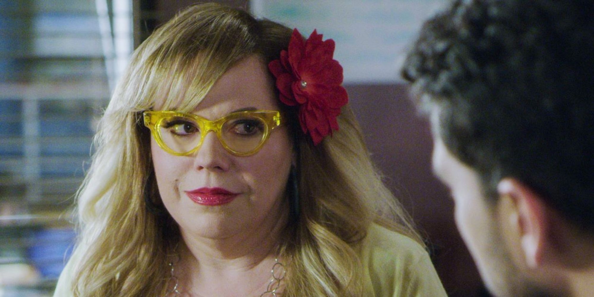 A blonde woman talking to a man emotionally
