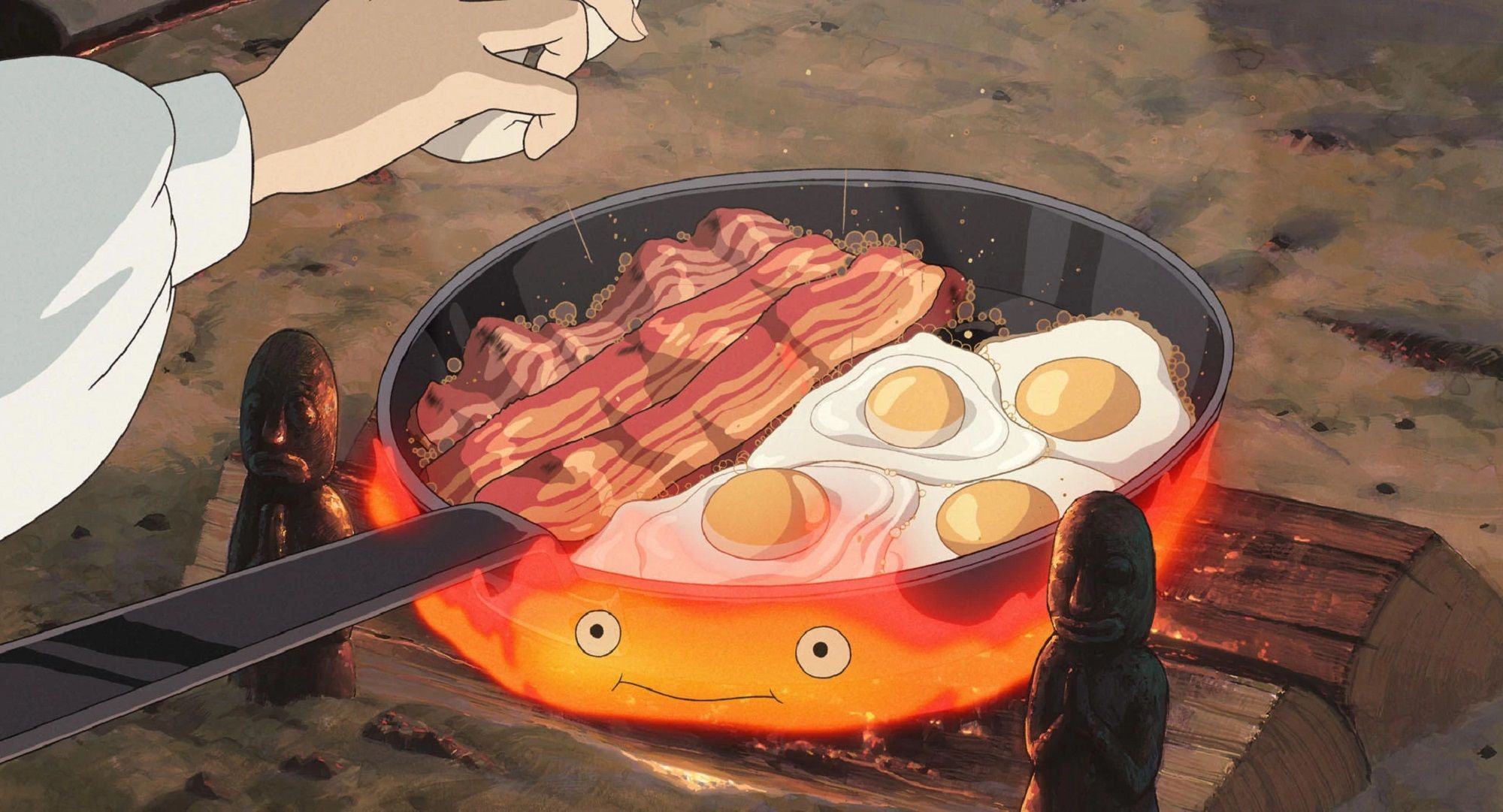 Calcifer cooking eggs and bacon in Howl's Moving Castle.