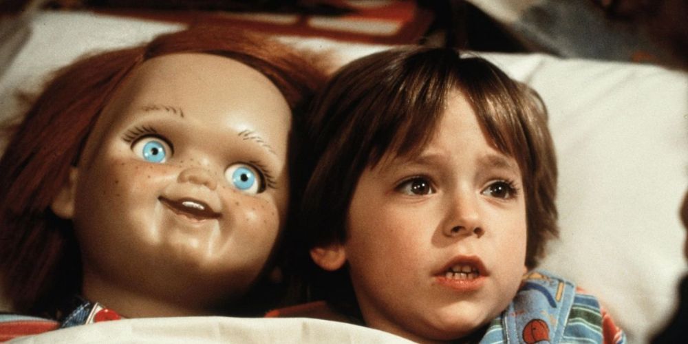 Alex Vincent as Andy in bed with Chucky in Child's Play