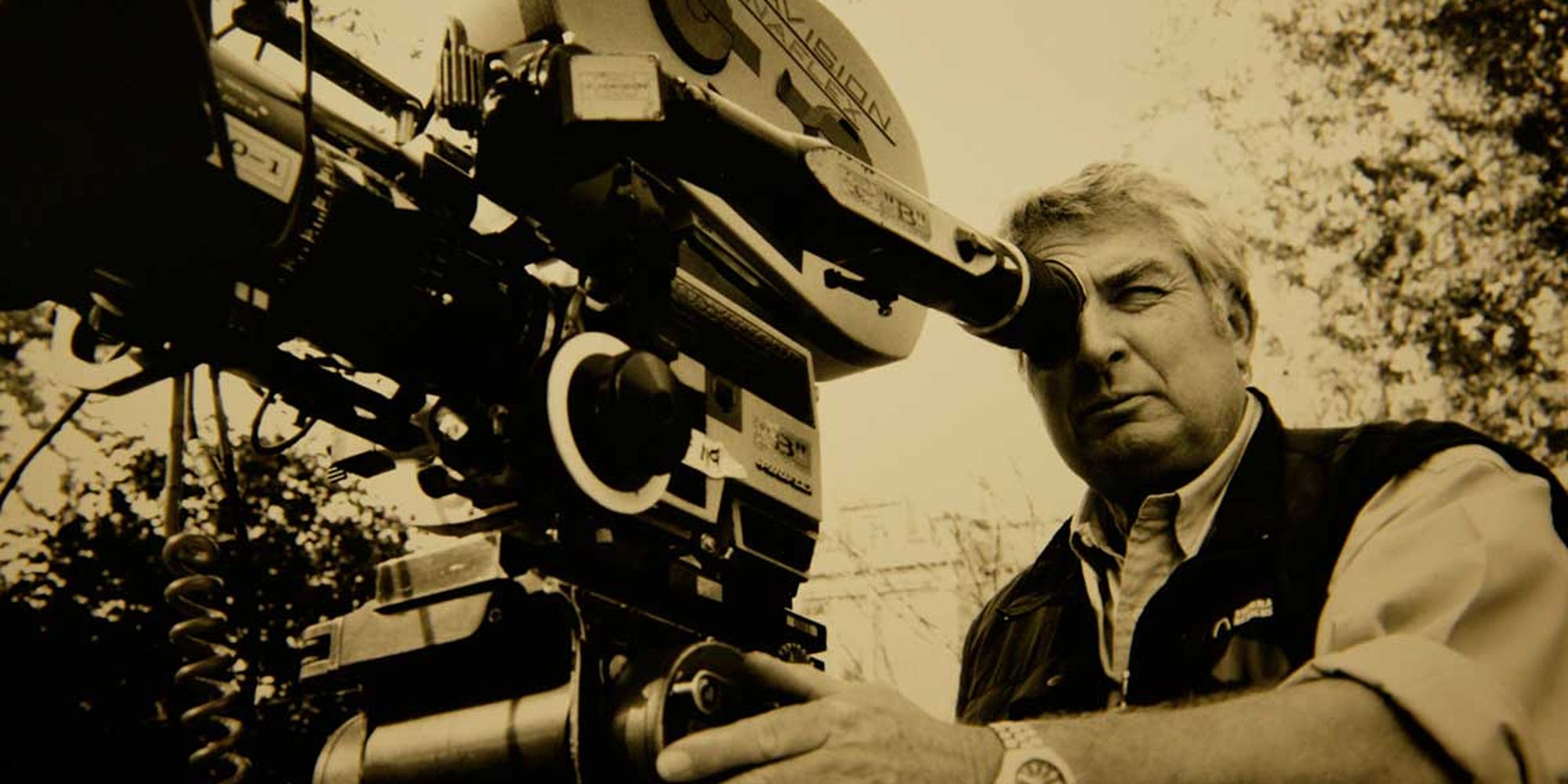 cinematographer Dean Semler with a movie camera