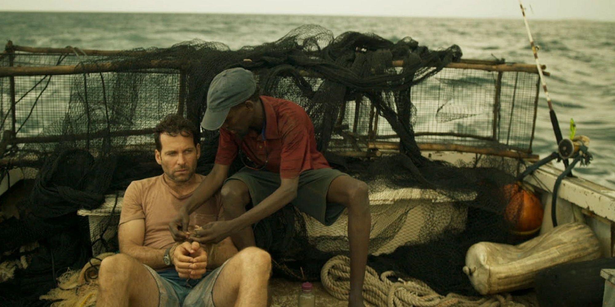 Eion Bailey being captured by Barkhad Abdi on a boat in Extortion.