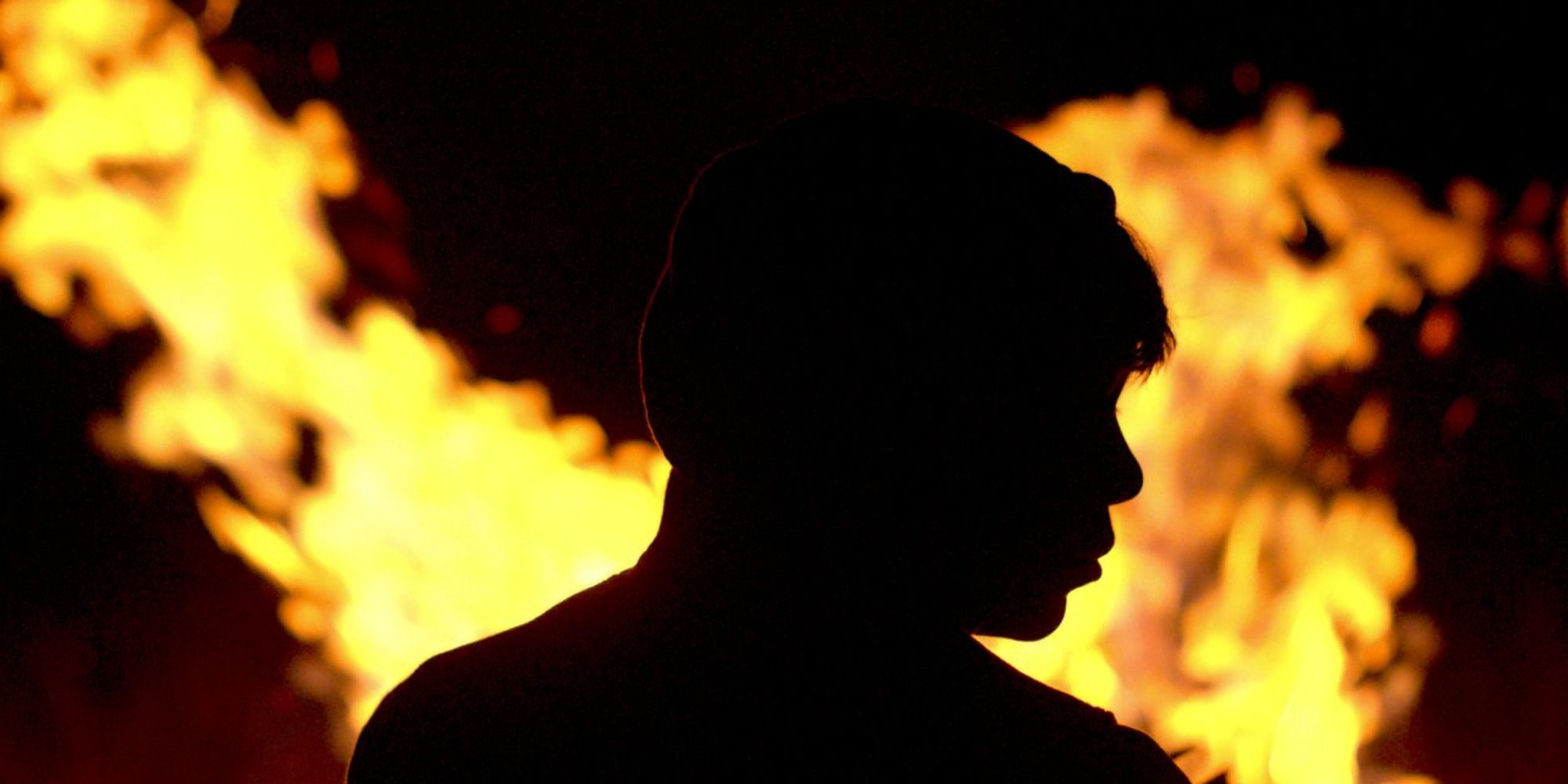 an obscured figure in front of fire from film "Identifying Features"