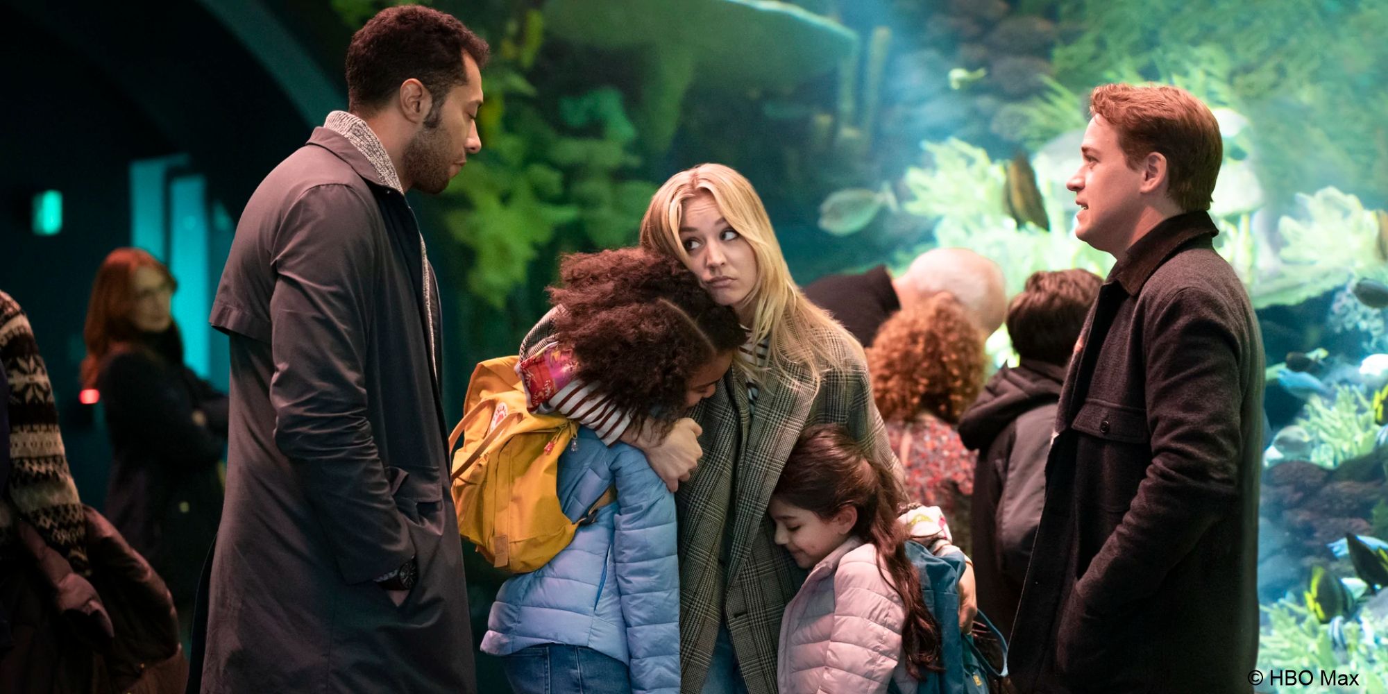 Cassie hugs her nieces while looking plaintively at her brother&rsquo;s husband