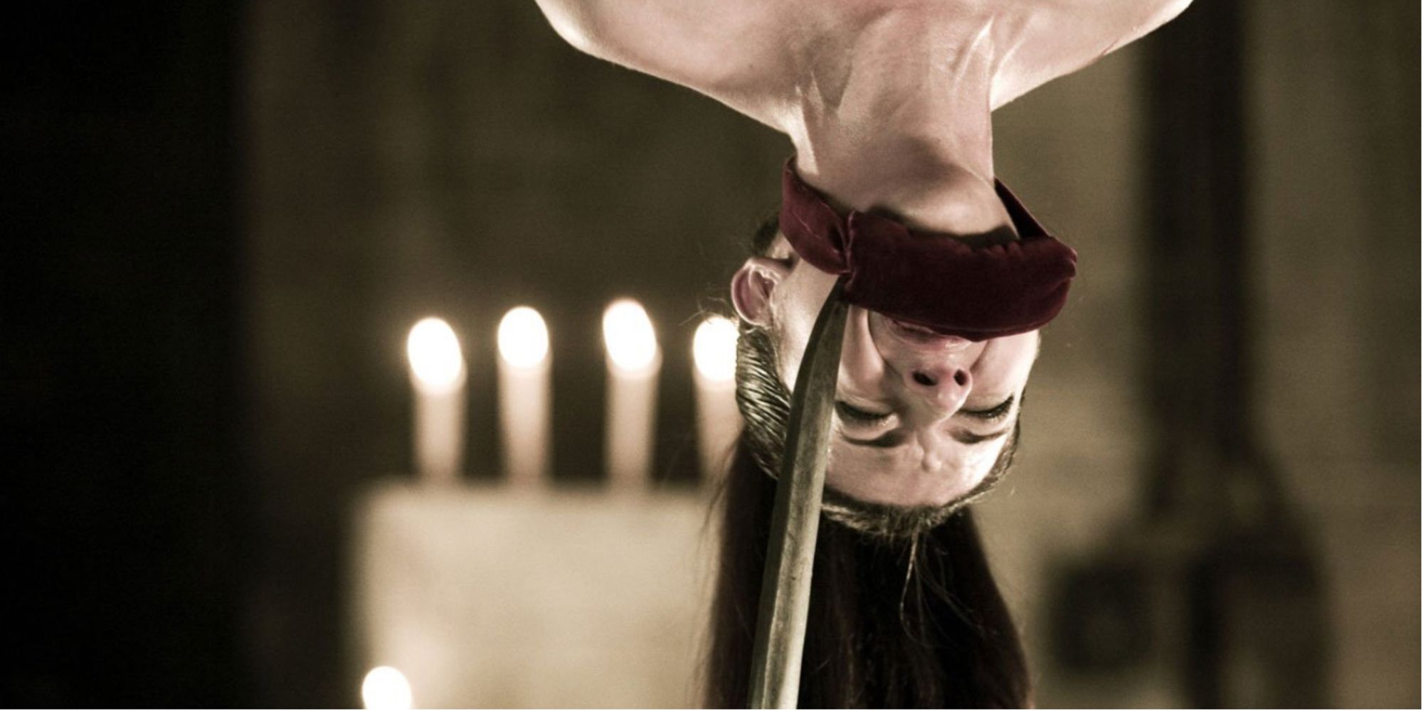Heather Matarazzo hangs upside down while gagged, a scythe near her face in Hostel Part II